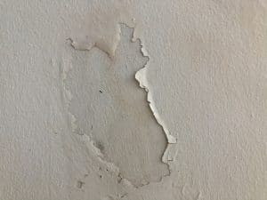 Cracked flaking white paint background texture.